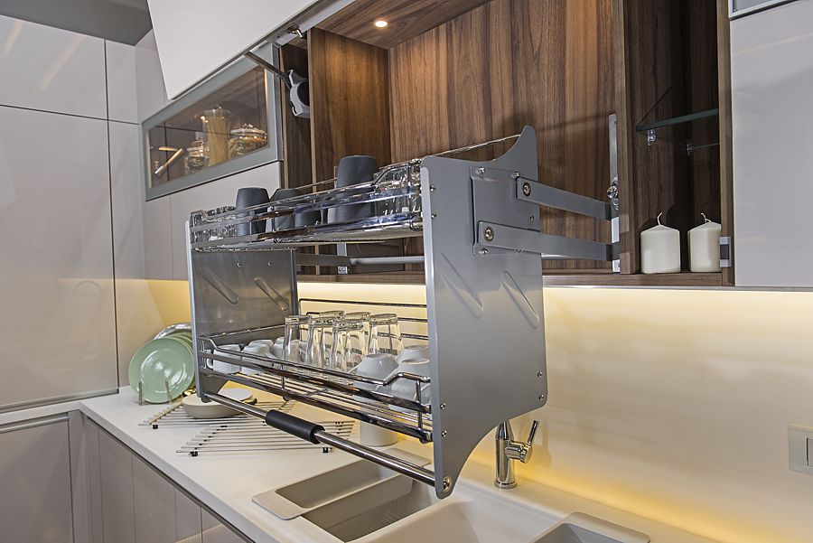 Interior design decor of kitchen in luxury apartment showing closeup detail of cupboard with pull down shelf